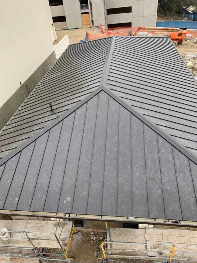 Commercial metal roof construction with crane equipment in Lino Lakes