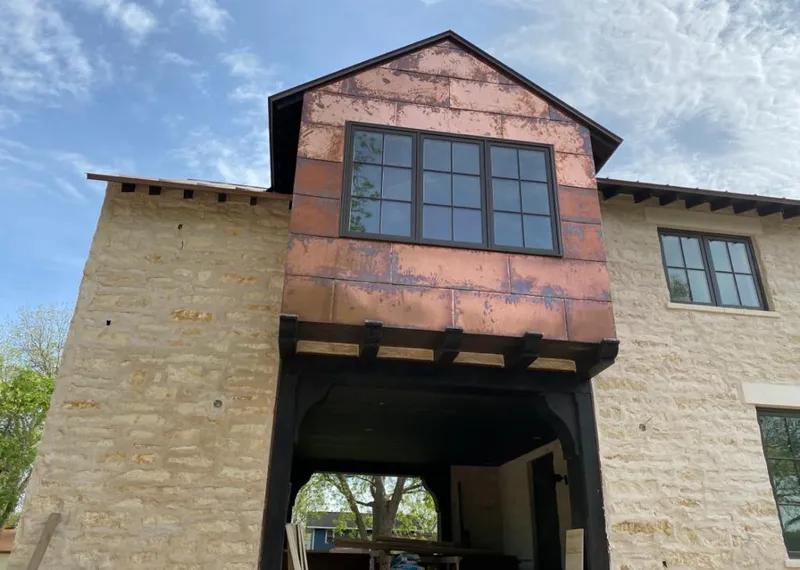 Copper metal panel facade on a stone building for Skylight Installation in Lino Lakes